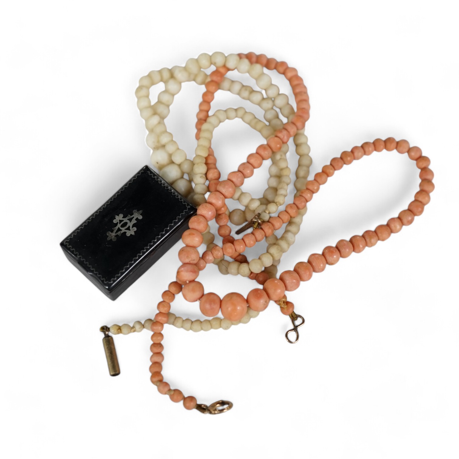 A single strand graduated coral bead necklace, 40cm, a similar white coral bead necklace, together with a small snuff box and loose simulated pearls. Condition - poor to fair